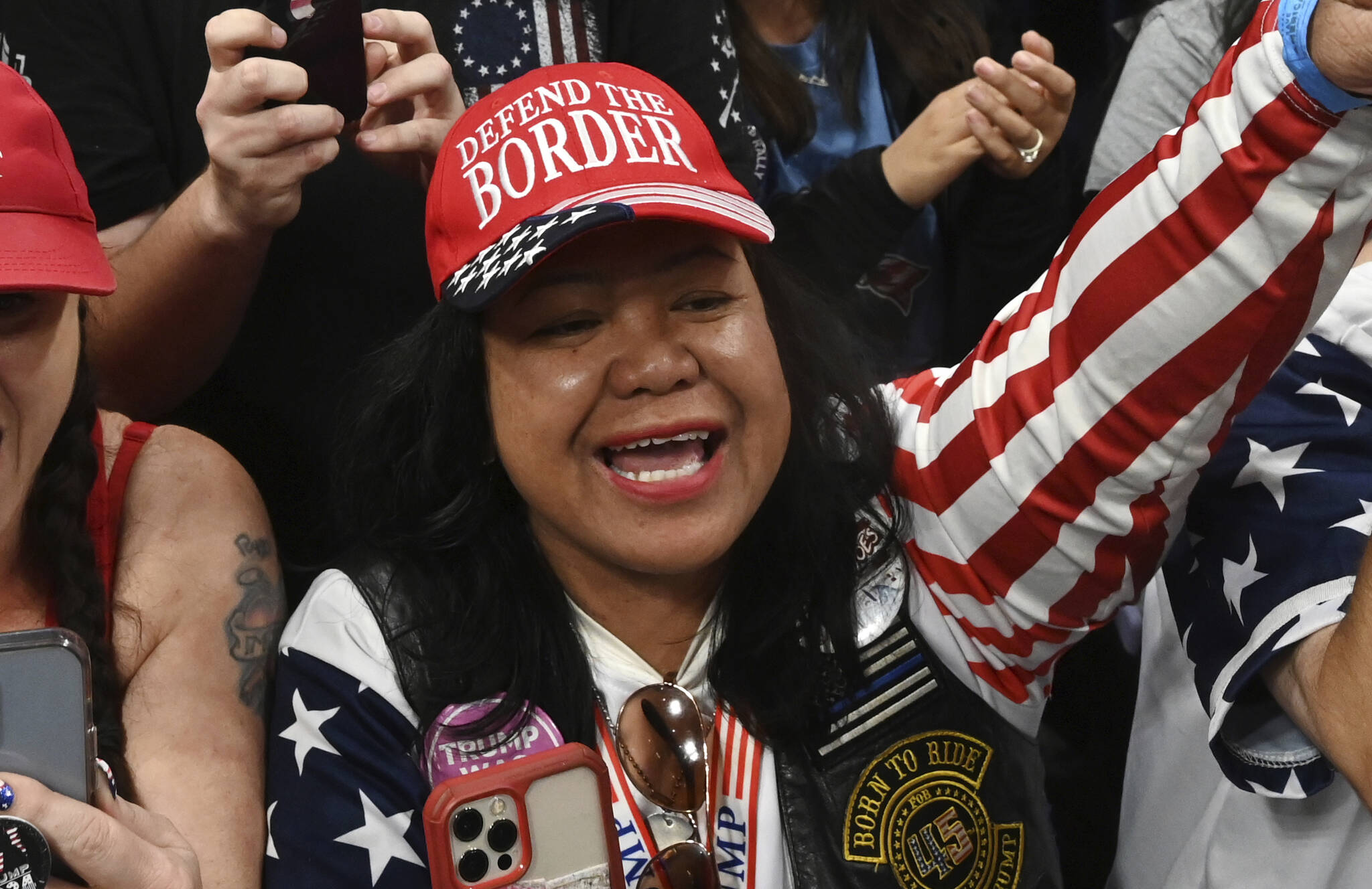 Mimi Israelah, center, cheers for Donald Trump inside the Alaska Airlines Center in Anchorage, Alaska, during a rally Saturday July 9, 2022. Two Anchorage police officers violated department policy during a traffic stop last month when Israelah, in town for a rally by former President Donald Trump showed a "white privilege card" instead of a driver's license and was not ticketed. (Bill Roth / Anchorage Daily News)