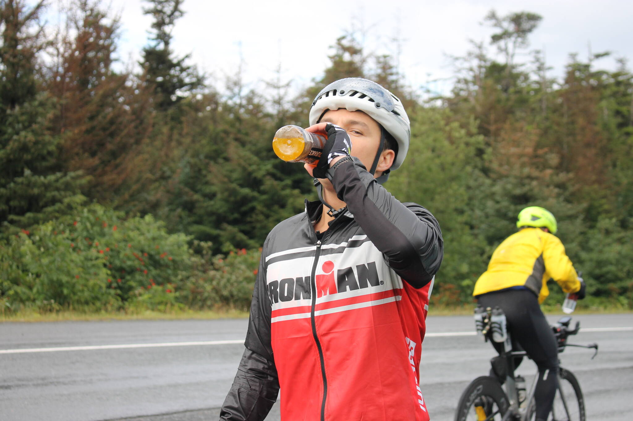 Johnny Byrne from Southern California grabs a much needed drink of Gatorade mid-way through the 112-mile bike portion of the Ironman Alaska. (Clarise Larson/ Juneau Empire)