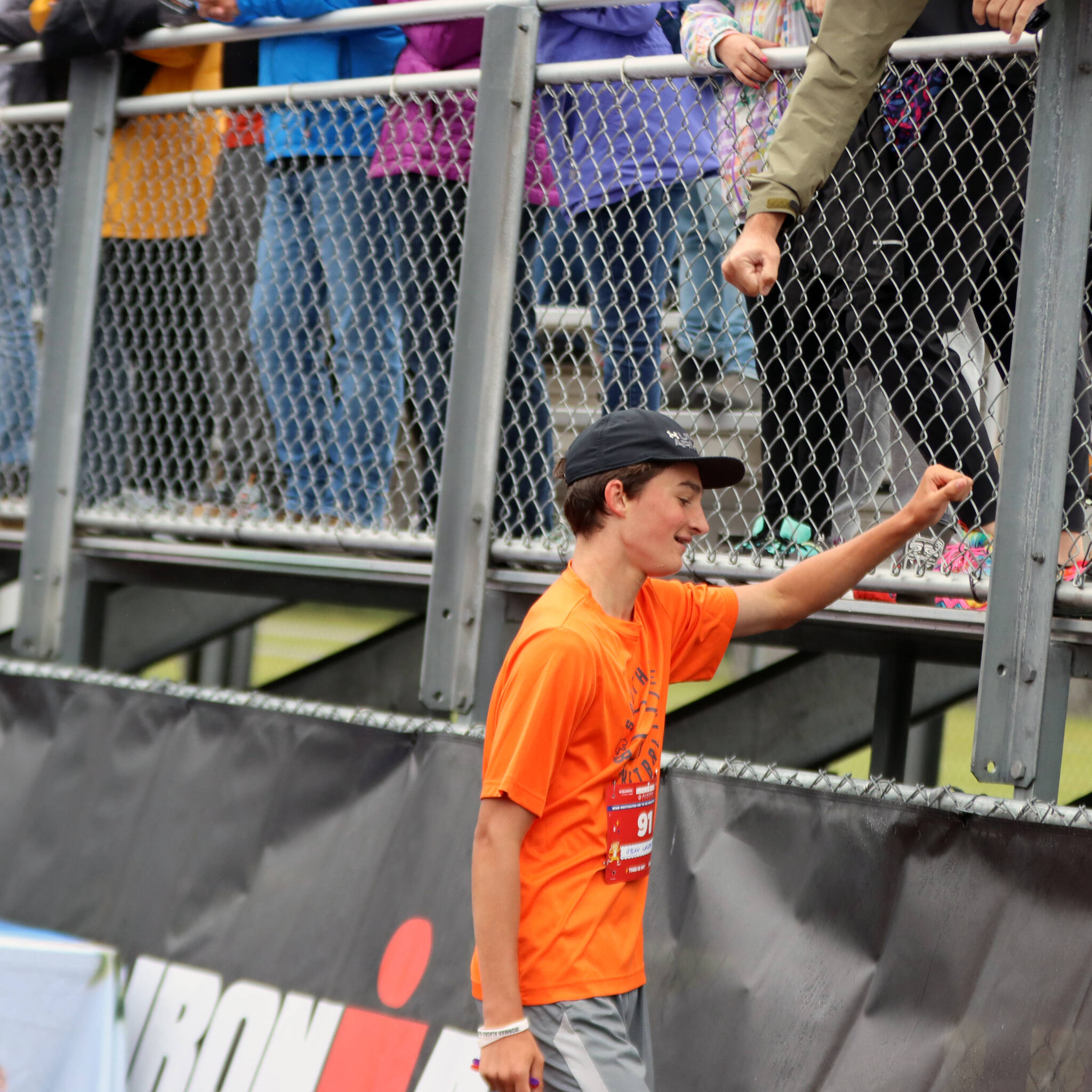 Dylyan Walerius, 14, of Sylvania, Ohio, lowers his hand after giving a fistbump shortly after finishing a 1-mile run. Walerius, who was in town with an adult competing in Ironman Alaska, said the 1600-meter is his event in track. It was evident as Walerius finished in second place in his fun run heat. (Ben Hohenstatt / Juneau Empire)