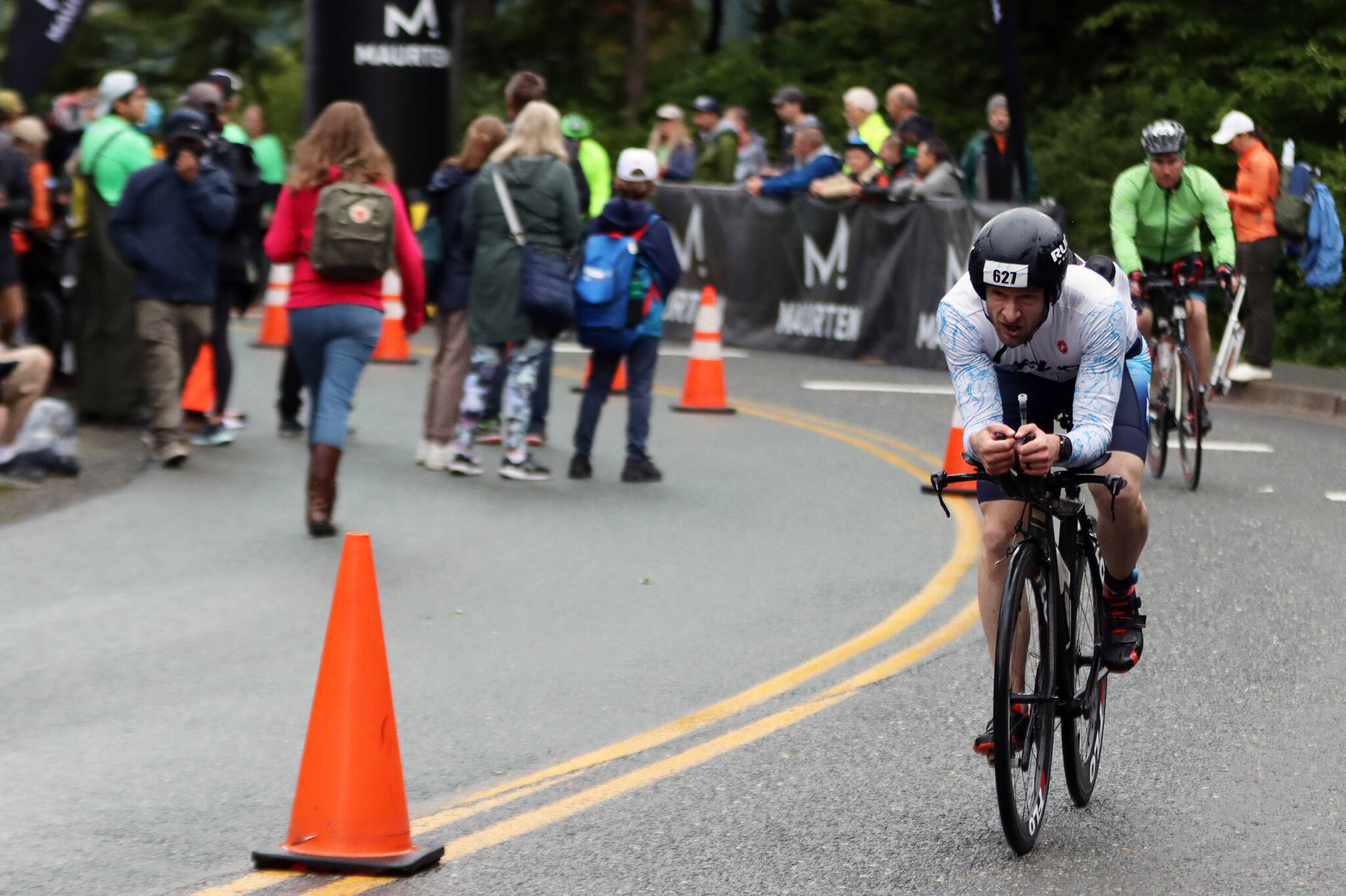 Will Coleman, the Juneau resident with the fastest time in the first-ever Ironman Alaska, pedals away from the University of Alaska Southeast campus on Sunday. (Ben Hohenstatt / Juneau Empire)