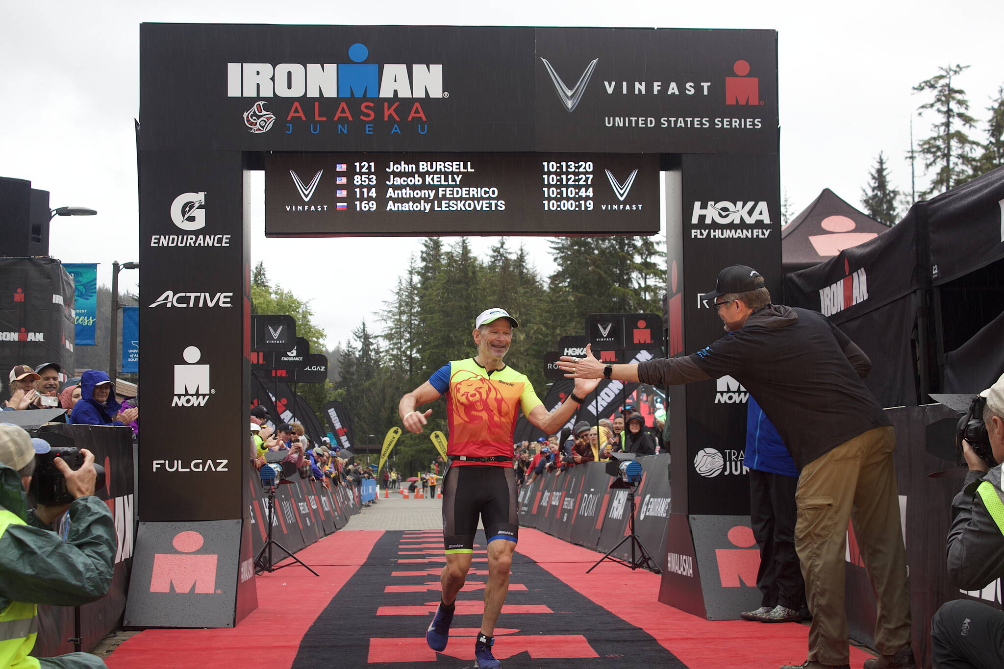 John Bursell, 58, a Juneau resident and veteran of more than 20 Ironman races, finishes the Ironman Alaska with a time of 10:13:20. He was hailed by the race announcer as the first Juneauite to cross the finish line, which occurred because he was among the earliest of the participants who had staggered starting times, although he actually finished about 10 minutes slower than the fastest local resident. (Mark Sabbatini / Juneau Empire)