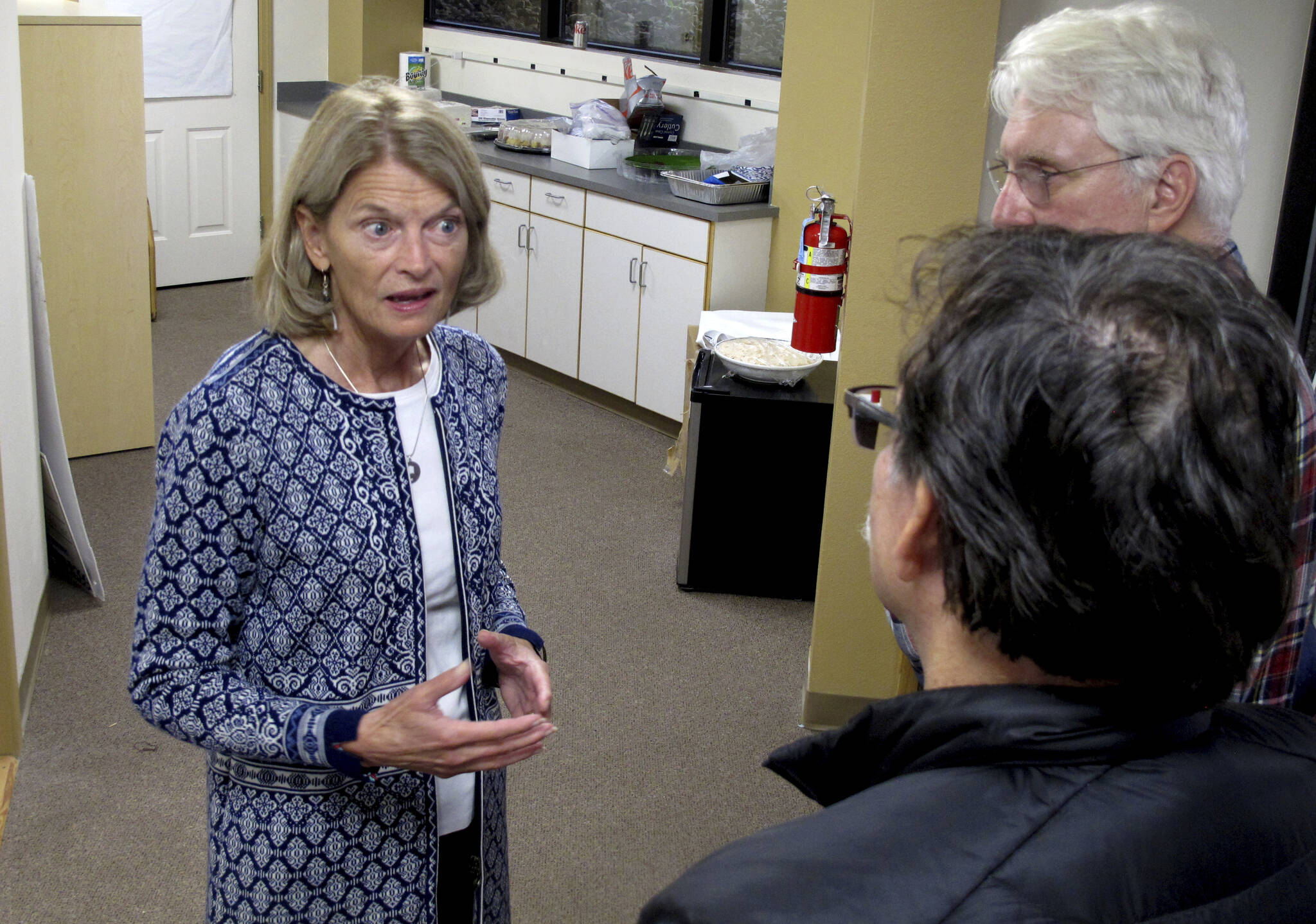 Alaska U.S. Sen. Lisa Murkowski, left, speaks with supporters at the grand opening of her reelection campaign office in Juneau, Alaska, on Thursday, Aug. 11, 2022. Murkowski said she expects to be among the candidates who will advance from the Aug. 16, 2022, U.S. Senate primary in Alaska. Under a system approved by voters and being used in Alaska for the first time this year, the top four vote-getters in the primary, regardless of party affiliation, will advance to the November general election, in which ranked voting will be used. (AP Photo / Becky Bohrer)