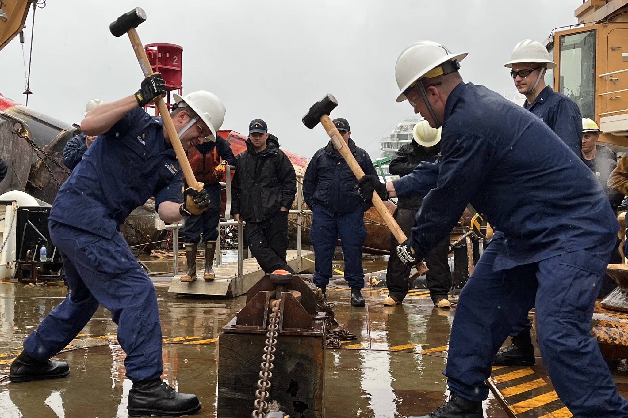 Heat and Beat featured in this photo is one of the events held in the Buoy Tender Olympics, which has teams smashing smoldering chains as a way of breaking off rusted ends and connecting new links with a pin. (Jonson Kuhn / Juneau Empire)