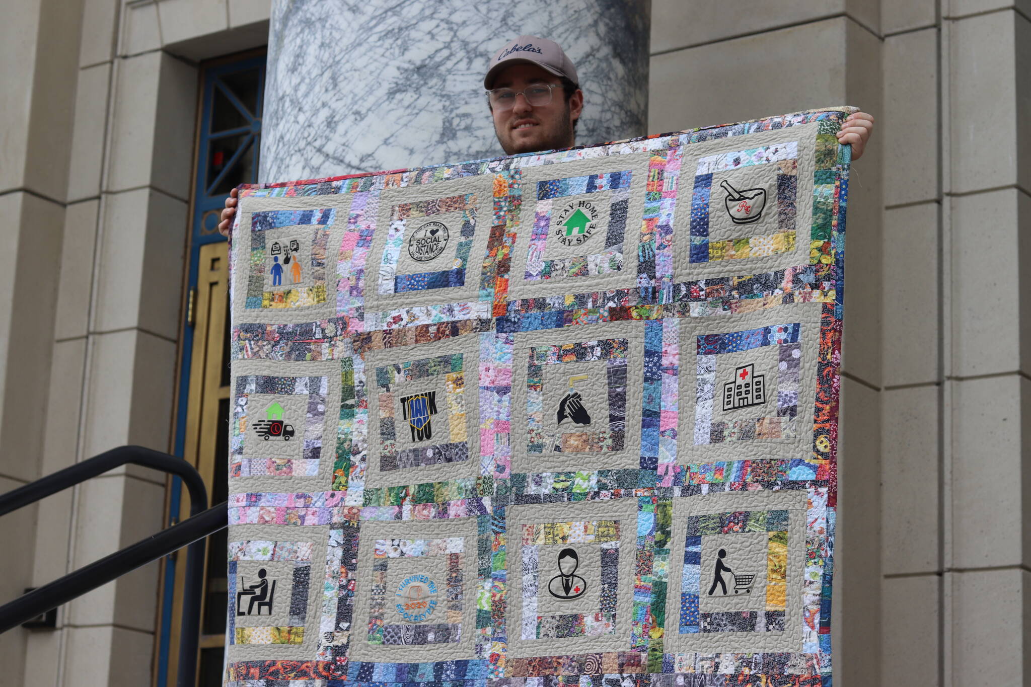 William Stich-Smith stands on the steps of the Alaska State Capitol building on Tuesday morning to showcase his pandemic quilt, which he’s currently touring all throughout the country. Alaska marks the 39th state he’s traveled to so far. (Jonson Kuhn / Juneau Empire)