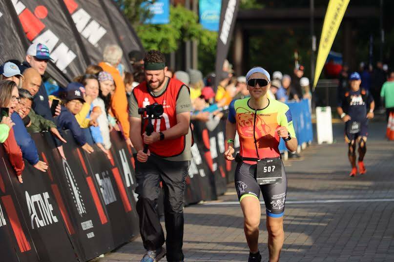 Jonson Kuhn / Juneau Empire File 
Juneau resident Corrie Weikle heads to to finish line during the Ironman Alaska in early Aug. Weikle has qualified for the VinFast Ironman World Championship and preparation is already underway to get ready to race in just under six weeks.