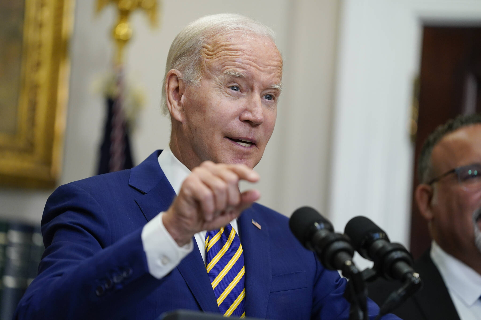 President Joe Biden speaks about student loan debt forgiveness in the Roosevelt Room of the White House, Wednesday, Aug. 24, 2022, in Washington. Education Secretary Miguel Cardona listens at right. (AP Photo / Evan Vucci)