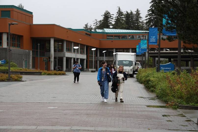 Students smile as the walk to their classes for the first day of fall semester at the University of Alaska Southeast on Monday morning. (Clarise Larson / Juneau Empire)