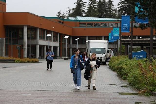 Students smile as the walk to their classes for the first day of fall semester at the University of Alaska Southeast on Monday morning. (Clarise Larson / Juneau Empire)