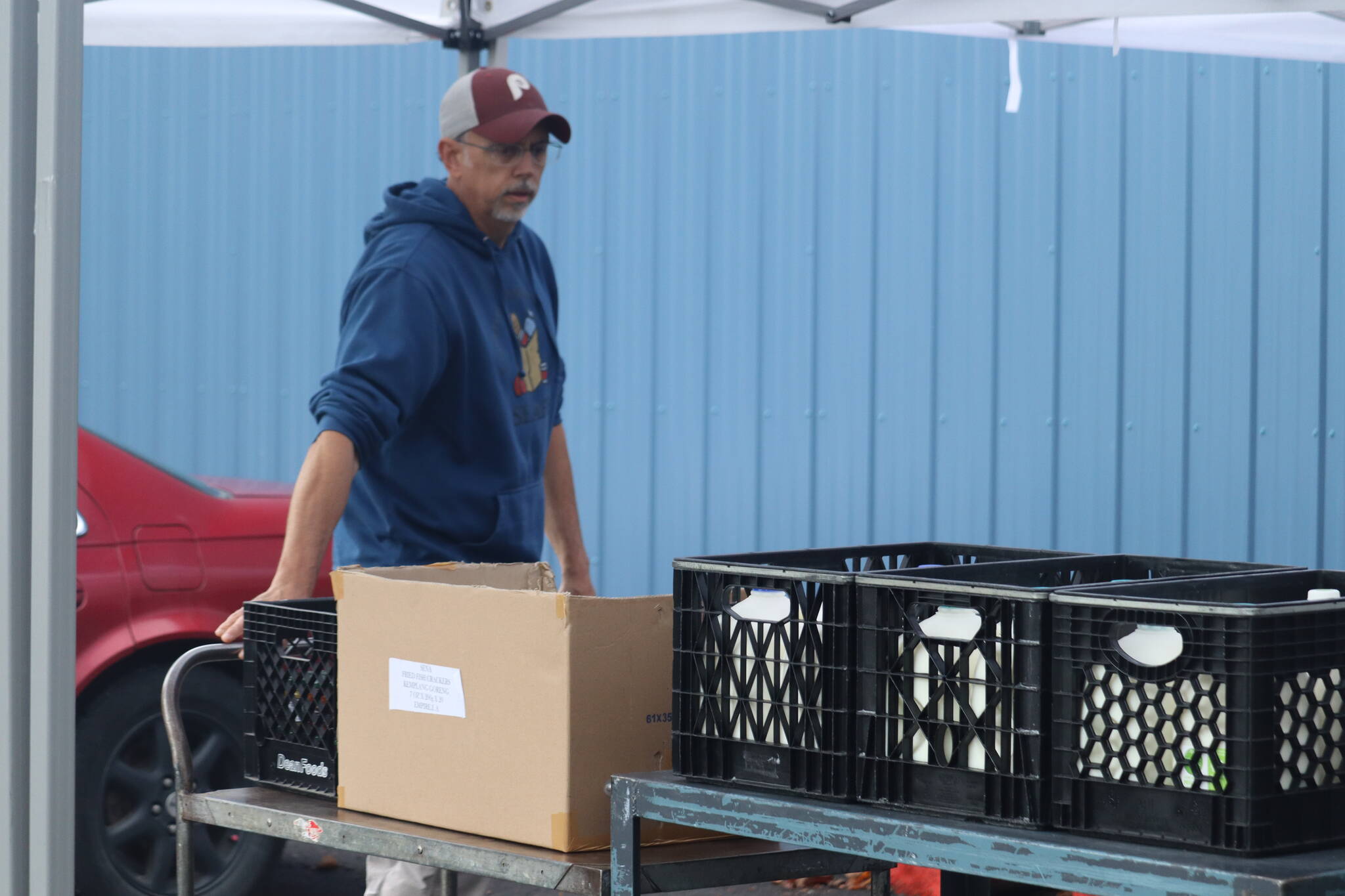 Jonson Kuhn / Juneau Empire 
Southeast Alaska Food Bank director Chris Schapp helps set up on Tuesday afternoon for a long and eager line of people waiting for the pantry to open.