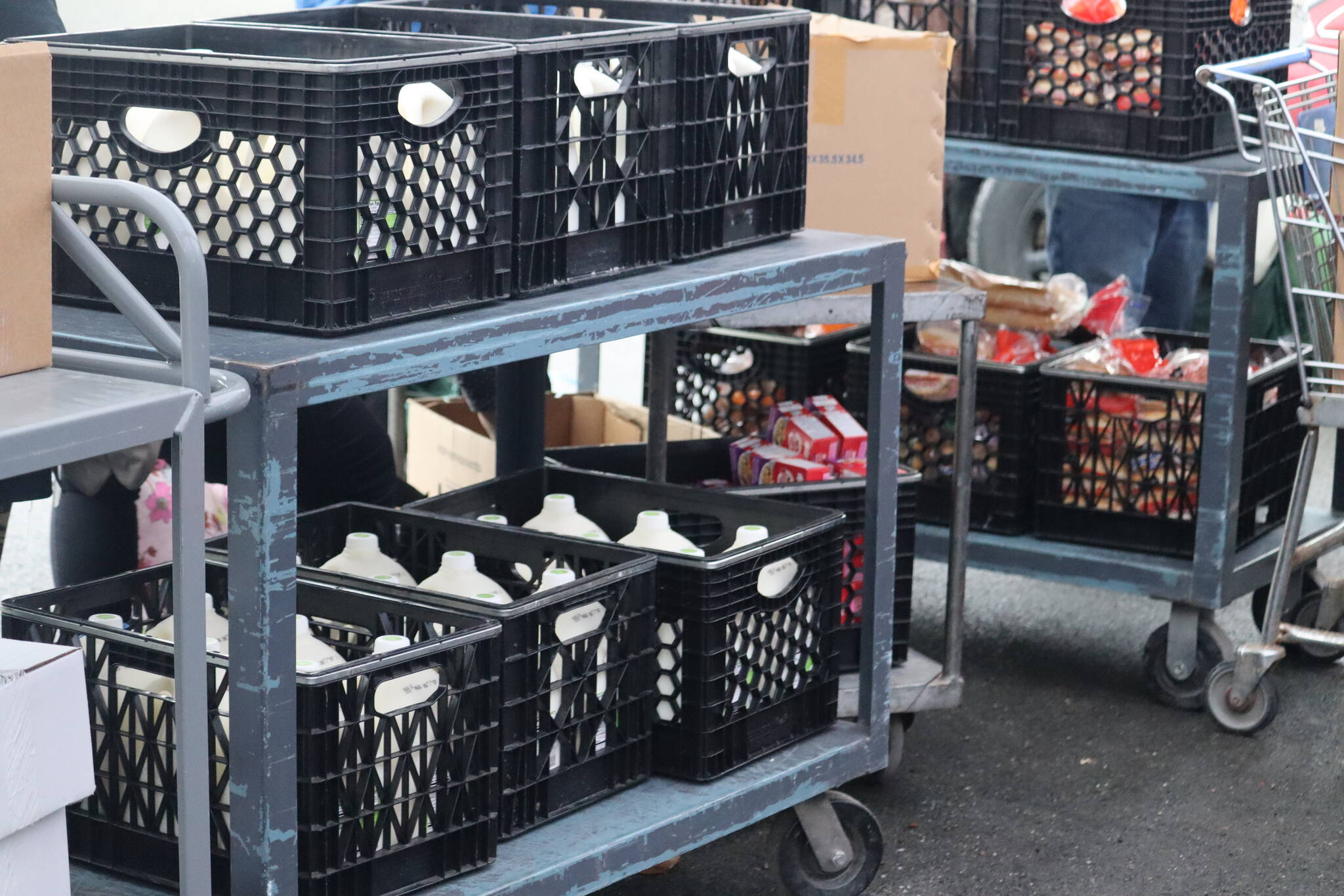 Not only do members of the Juneau community rely on Southeast Alaska Food Bank for food supplies such as milk and bread as seen in this picture, but so do various organizations such as the Resurrection Church, who are also facing higher demands of their own. (Jonson Kuhn / Juneau Empire)