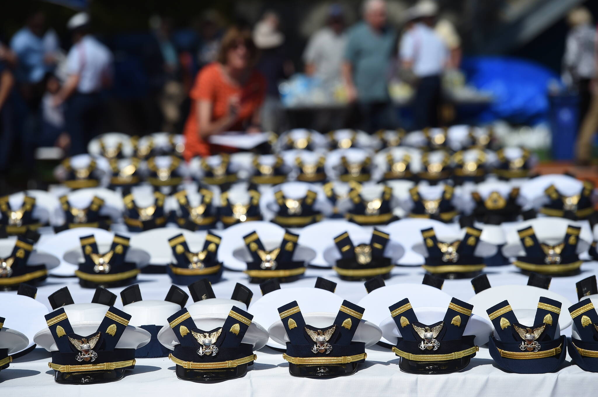The new hats and shoulder bars for the graduates sit on a table before the start of the U.S. Coast Guard Academy’s 141st Commencement Exercises Wednesday, May 18, 2022 in New London, Conn. The Coast Guard Academy is “disenrolling” seven cadets for failing to comply with the military’s COVID-19 vaccination mandate, after their requests for religious exemptions were denied and they were ordered to leave campus. The academy in New London, Connecticut, confirmed the disenrollments Tuesday, Aug. 30, 2022, The Day newspaper reported. (AP Photo / Stephen Dunn, File)