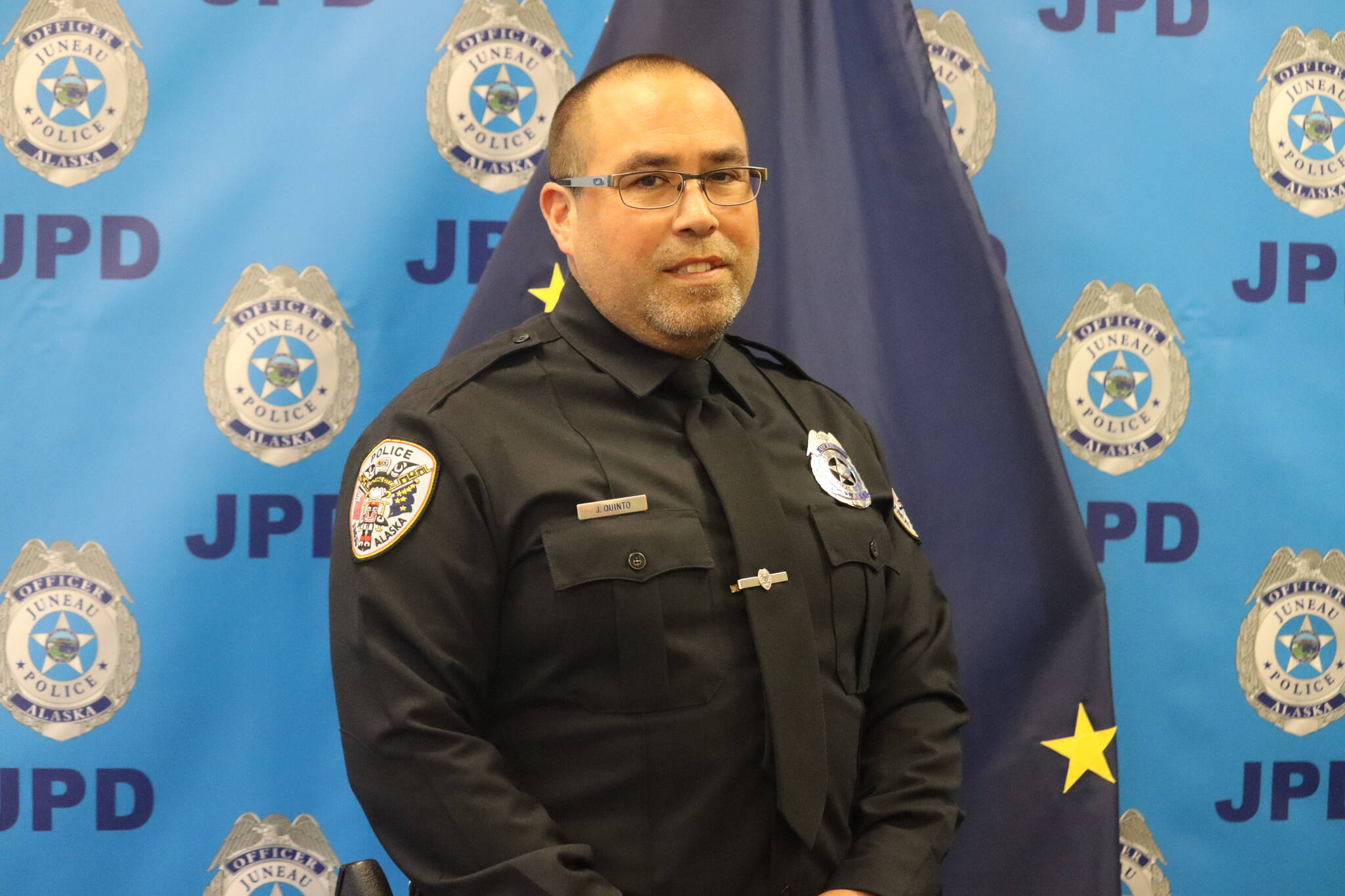 Jonson Kuhn / Juneau Empire 
Officer Jim Quinto stands for a photo on Friday at his retirement ceremony at the Juneau Police Department surrounded by family, friends and colleagues. Quinto started his career with JPD on September 2, 1997, exactly 25 years from the day of the ceremony.