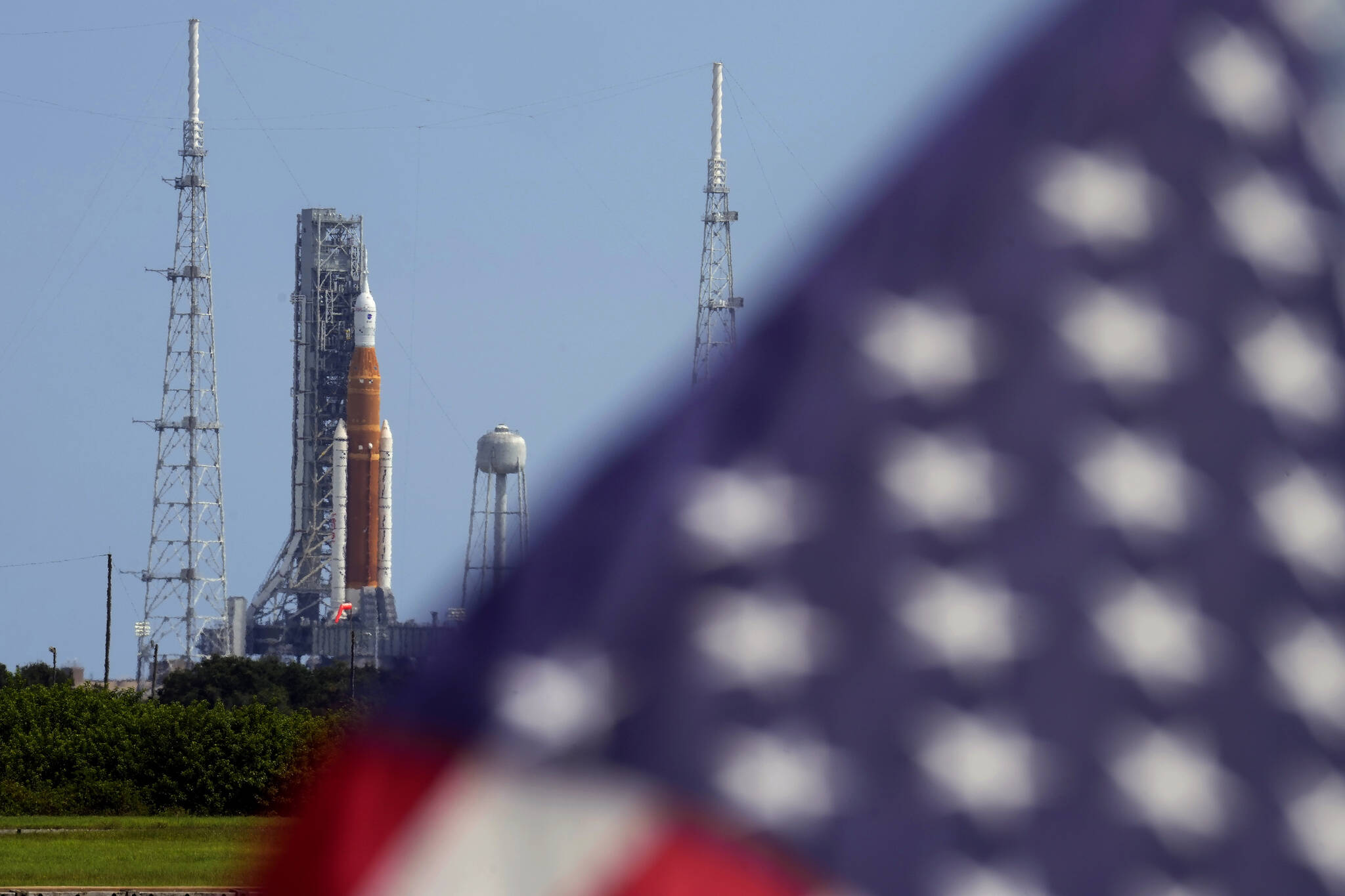 An American flag flies in the breeze as NASA’s new moon rocket sits on Launch Pad 39-B after being scrubbed at the Kennedy Space Center Saturday, Sept. 3, 2022, in Cape Canaveral, Fla. This is scheduled to be the first flight of NASA’s 21st-century moon-exploration program, named Artemis after Apollo’s mythological twin sister. (AP Photo / Chris O’Meara)