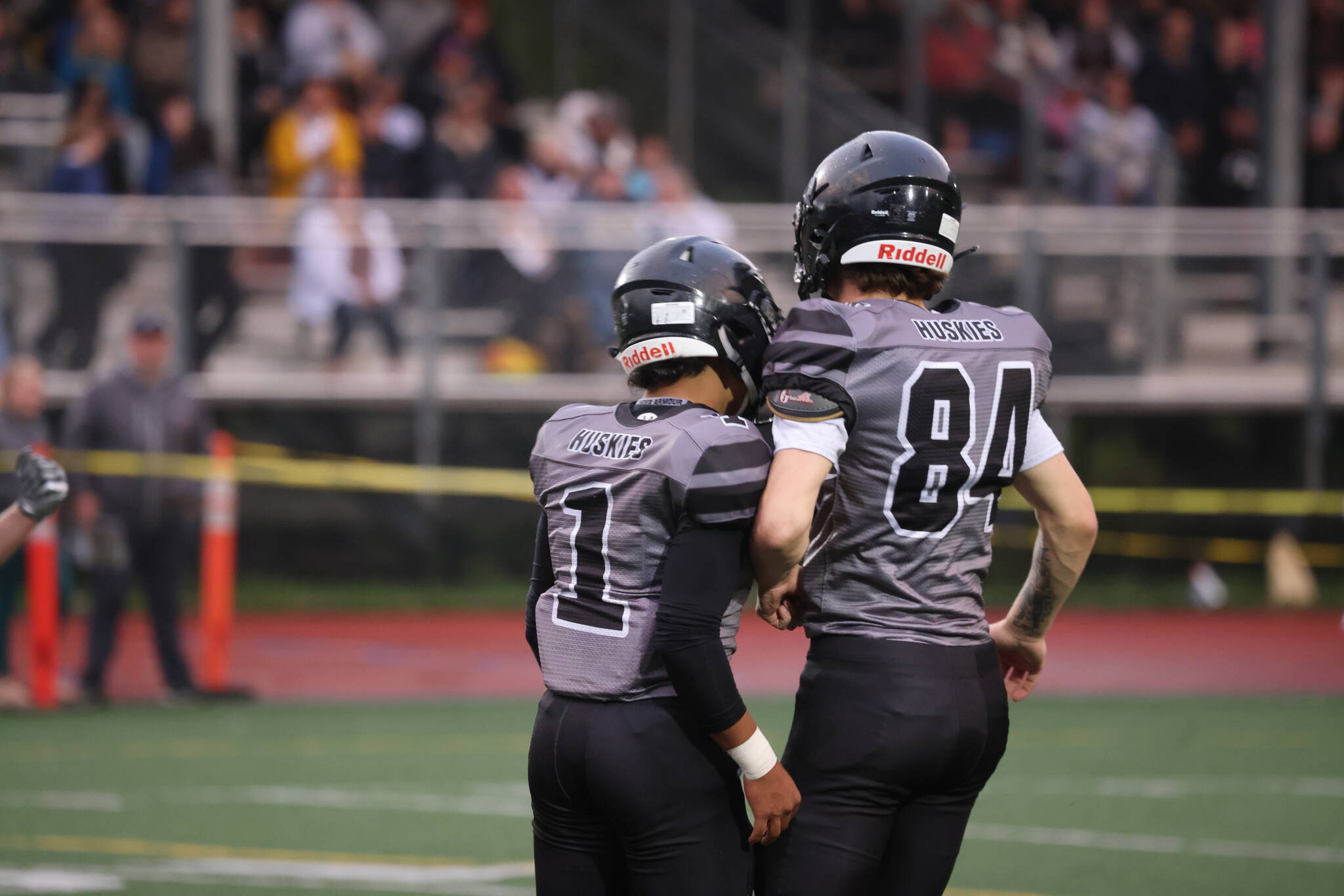 Jarrell Williams (1) and Thomas Baxter (84) celebrate a big play on defense early in Juneaus win over the visiting West Valley Rams. (Ben Hohenstatt / Juneau Empire)