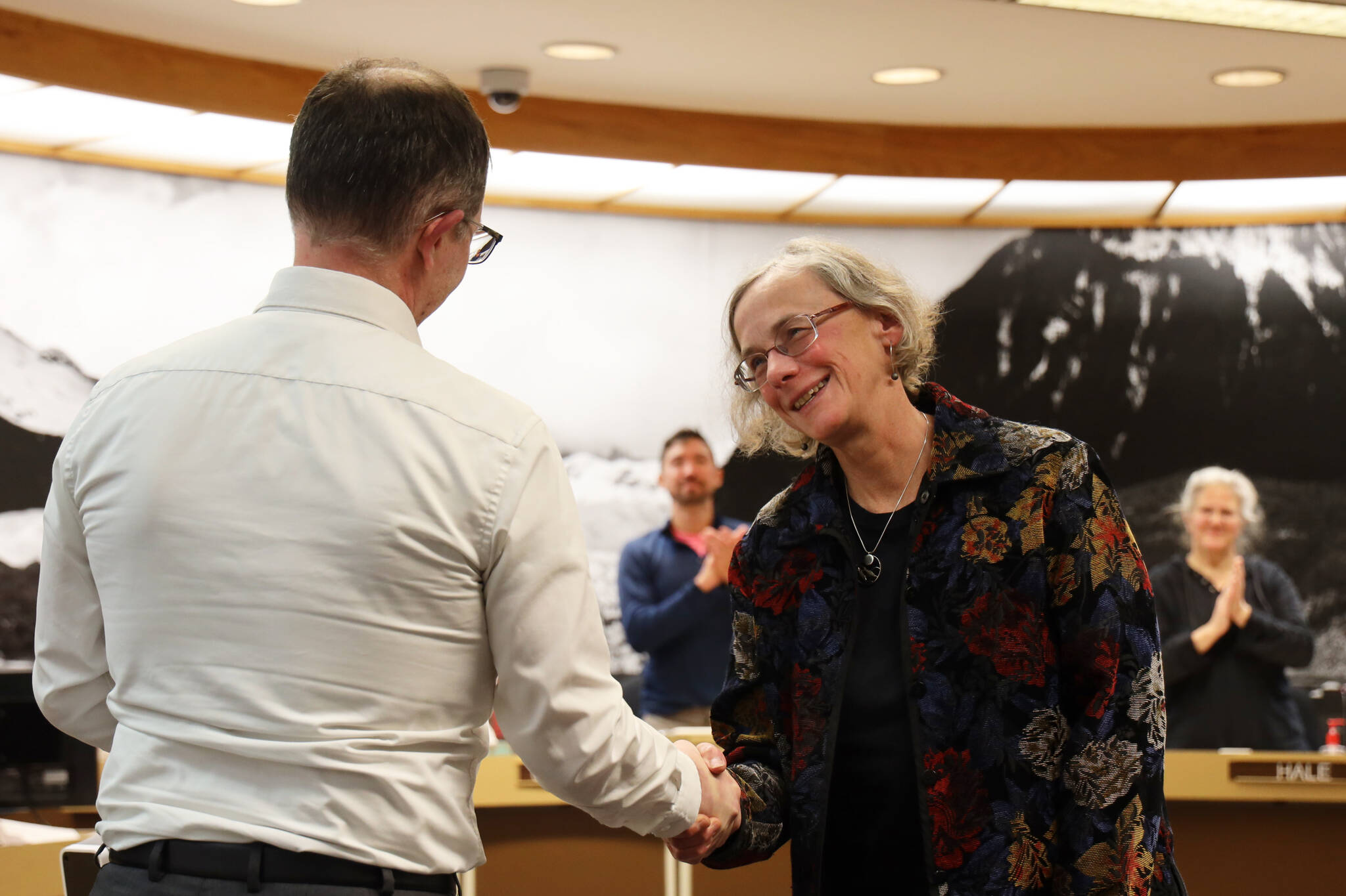 Mila Cosgrove shakes hands with Sen. Jesse Kiehl after receiving a plaque from the members of the Thirty-Second Alaska State Legislature that honored her for her state service. (Clarise Larson / Juneau Empire)