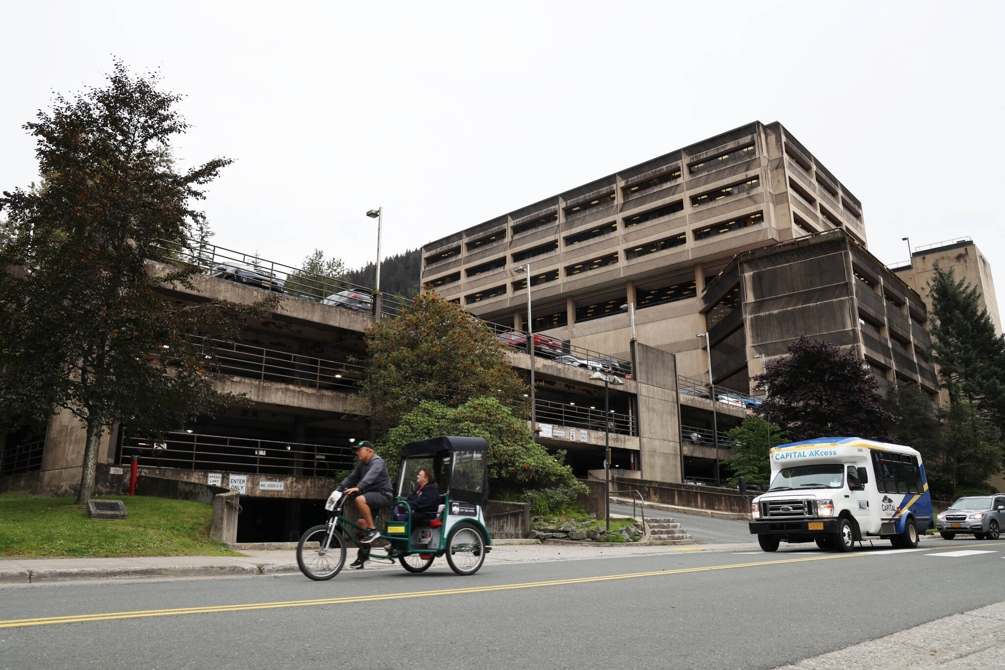 Clarise Larson / Juneau Empire
A cycle rickshaw passes the North State Office Building parking garage located on Willoughby Avenue in downtown Juneau. The City and Borough of Juneau’s Assembly passed an ordinance unopposed Monday night that gave the OK for the appropriation of $5 million to go toward partially funding the planning and construction of additional parking levels.