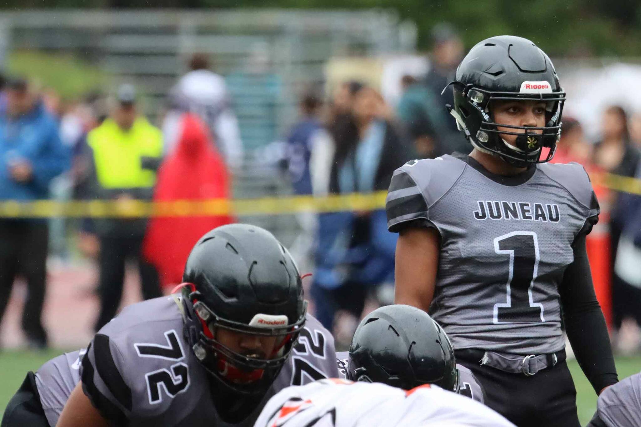 Jarrell Williams, who scored five TDs against South Anchorage to help Juneau maintain an undefeated record, looks over the line of scrimmage in an Aug. 27 game against West Anchorage High School. (Ben Hohenstatt / Juneau Empire File)