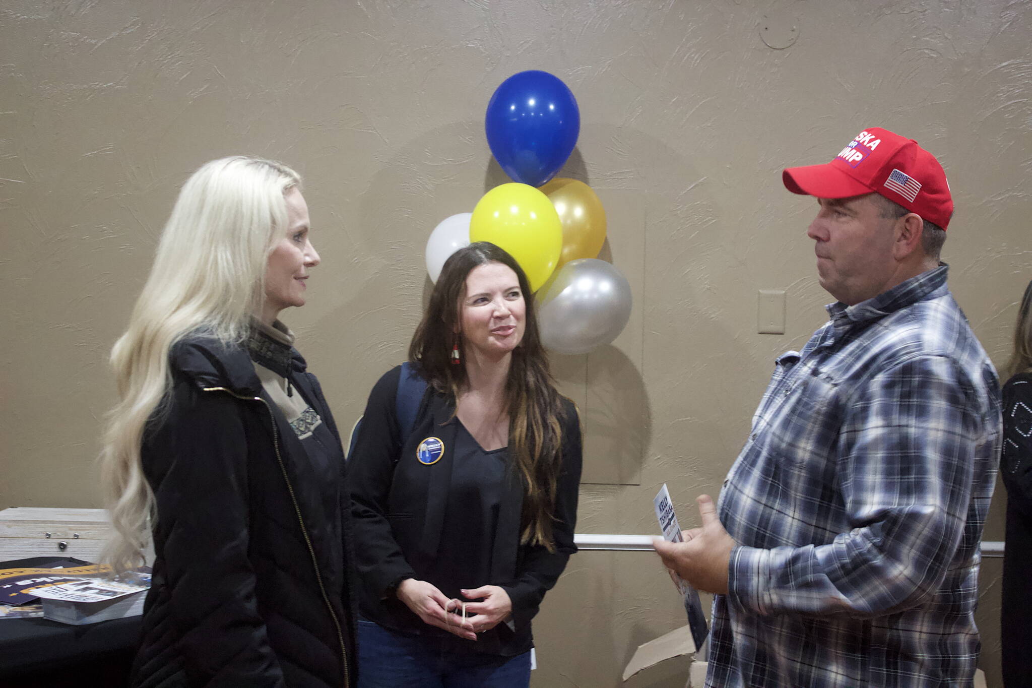 Patrick Phillips, right, a dock officer who has been a Juneau resident for 26 years, chats with Republican U.S. Senate candidate Kelly Tshibaka before the start of a meet-and-greet at Juneau Christian Center on Friday. He said he is voting for Tshibaka largely based on her stance on national issues. (Mark Sabbatini / Juneau Empire)