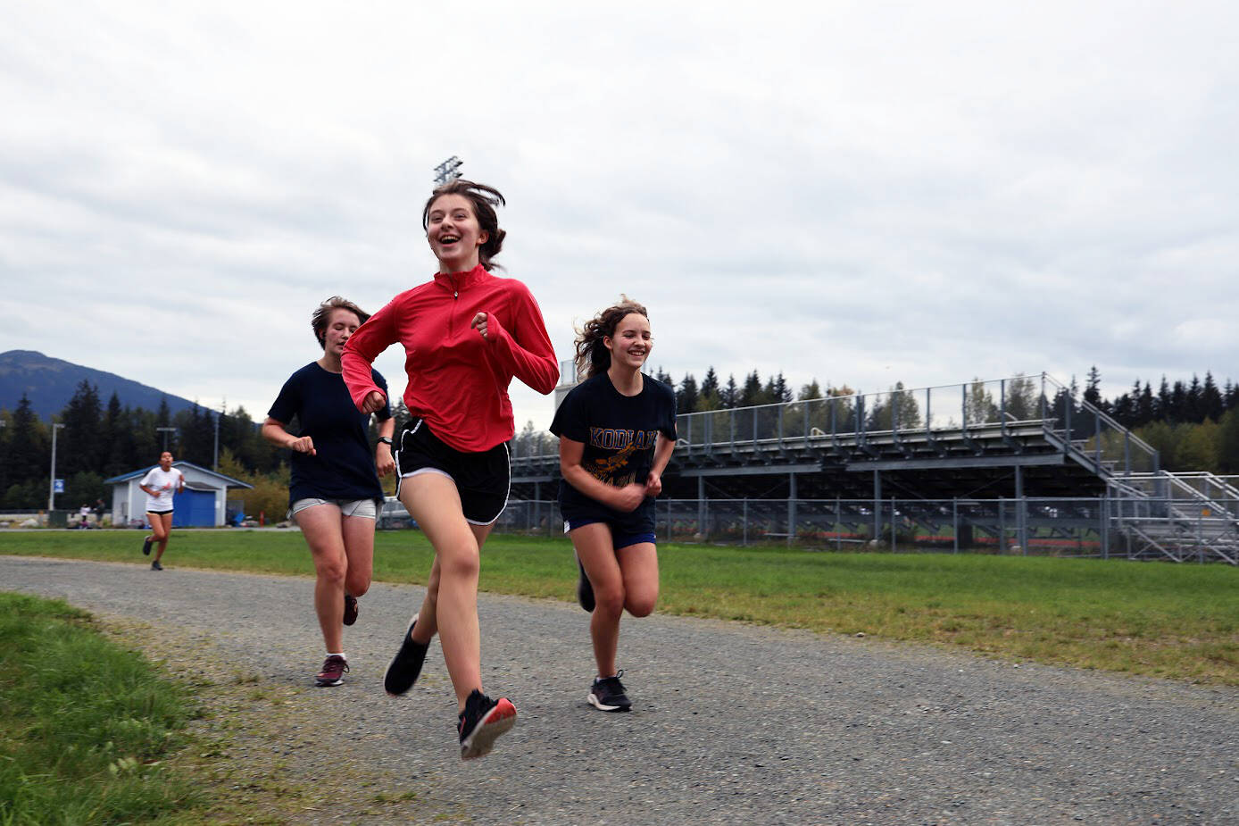 From left to right, Thunder Mountain High School cross country runners Randy Stichert, Piper Blackgoat and Kobe Yturbe finish up their run at cross country practice on Monday afternoon. (Clarise Larson / Juneau Empire)