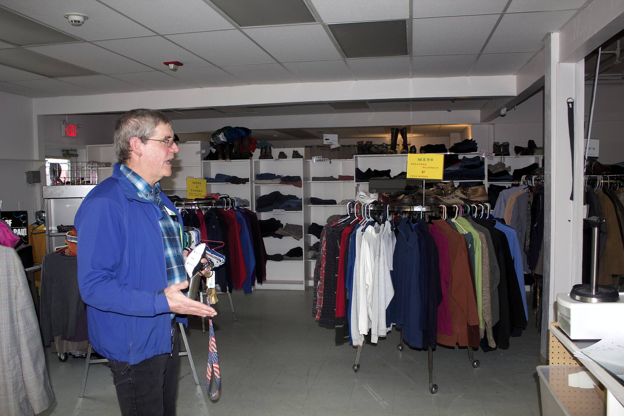 A program making clothing and household items available at the Dan Austin Free Store at the Society of St. Vincent de Paul’s Teal Street complex is explained Wednesday by Dave Ringle, executive director of the Juneau chapter of the non-profit organization. He said the store is currently “full,” due in part to the need for volunteers able to sort donations and staff the store, and that volunteers for other programs are also needed due to a shortage resulting from the COVID-19 pandemic and the aging of current volunteers. (Mark Sabbatini / Juneau Empire)