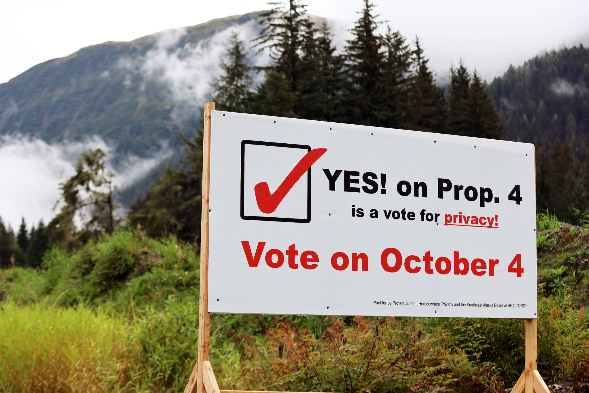 A sign encouraging voters to vote yes on Proposition 4 stands at a busy Mendnehall Valley intersection. The proposition to repeal a city ordinance requiring buyers to disclose the sales price of real property has been a flashpoint in the municipal election with groups forming in support and opposition of the prop. (Ben Hohenstatt / Juneau Empire)