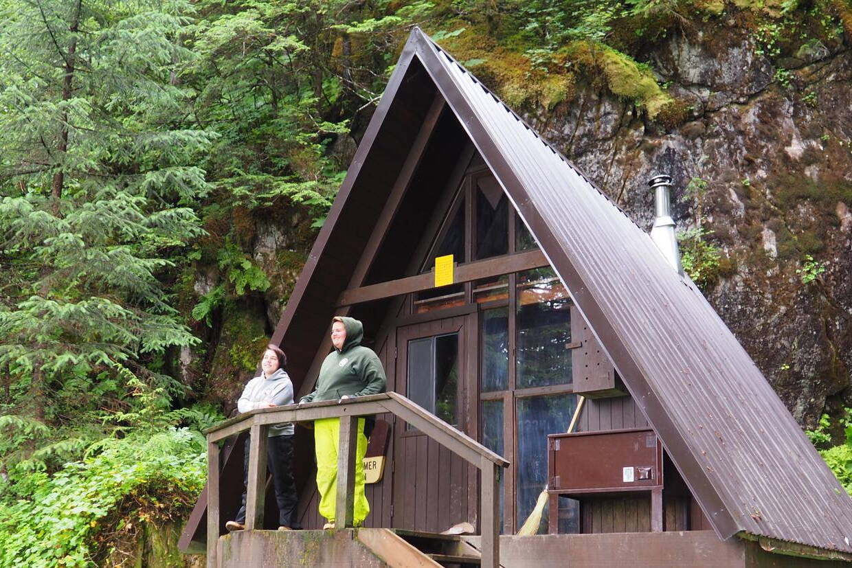 Visitors take in the view from the porch of the U.S. Forest Service’s Mount Flemer Cabin in the Wrangell Ranger District. The Forest Service is preparing to accept public input on how to spend about $14.4 million in federal funds for new cabins and repairing existing ones in Alaska, including an anticipated 10 to 12 new cabins in the Tongass National Forest. (U.S. Forest Service photo)
