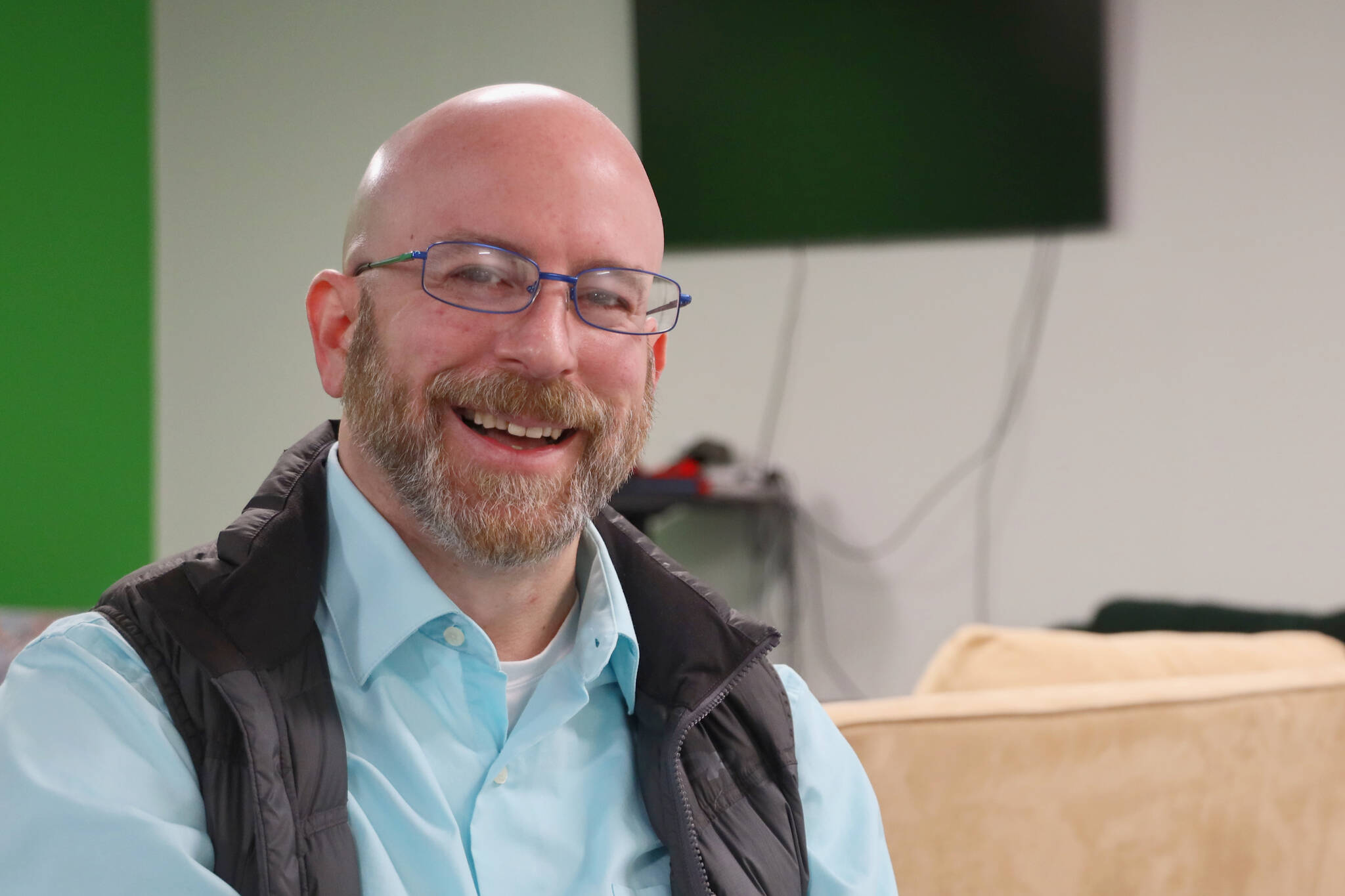 Assembly member Wade Bryson smiles while sitting in his office space located above the Juneau Bike Doctor off Old Dairy Road. Bryson is seeking reelection in this years City and Borough of Juneau municipal election, which comes to an end in less than a week on Oct. 4. (Clarise Larson / Juneau Empire)