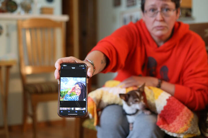 Clarise Larson / Juneau Empire
Michelle Rogers holds out her phone showing a painted portrait of Faith Rogers that was created by a friend. Family members described Faith Rogers as kind, loving, artistic and outdoorsy.