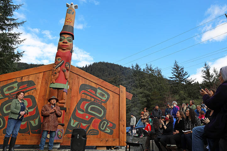 Tlingit master carver Wayne Price stands next to his wife, Cherri, in front of the healing totem pole and screens he created. Hundreds of people gathered in raincoats and boots at the Twin Lakes Kaasei Totem Plaza to witness the two-hour ceremony. (Clarise Larson / Juneau Empire)