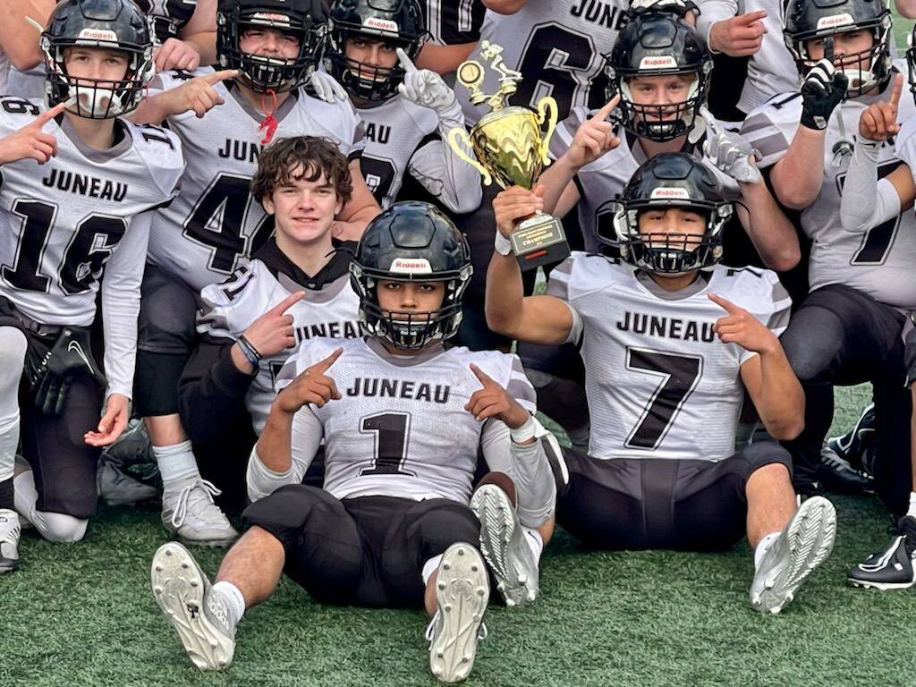 The Cook Inlet Conference champions pose with their trophy following a 19-14 win against Bettye Davis East Anchorage High School. (Courtesy Photo / Judy Campbell)