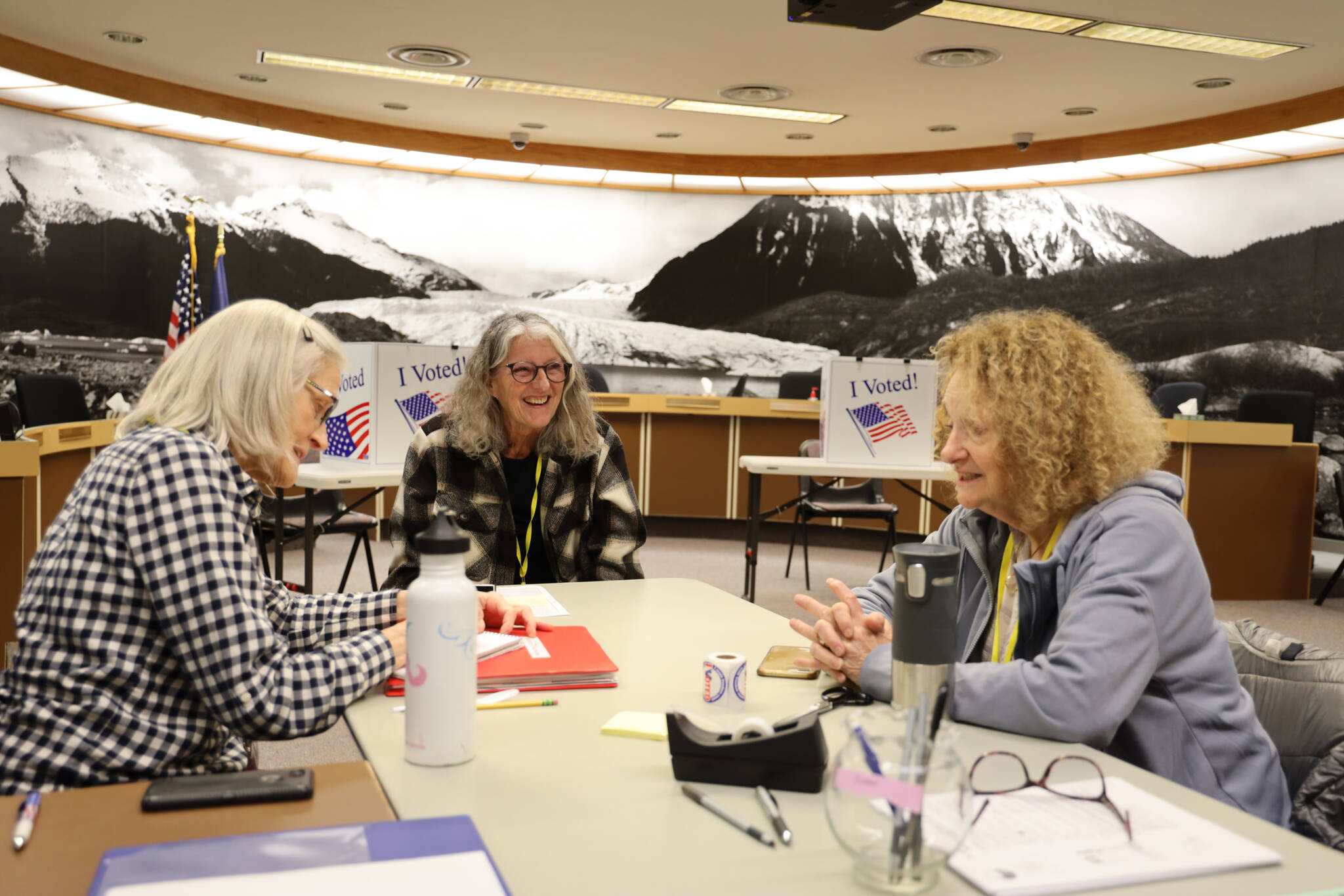 Clarise Larson / Juneau Empire 
Election officials sit at a table near the ballot box at the voter center located at City Hall Assembly Chambers on Election day Tuesday morning.