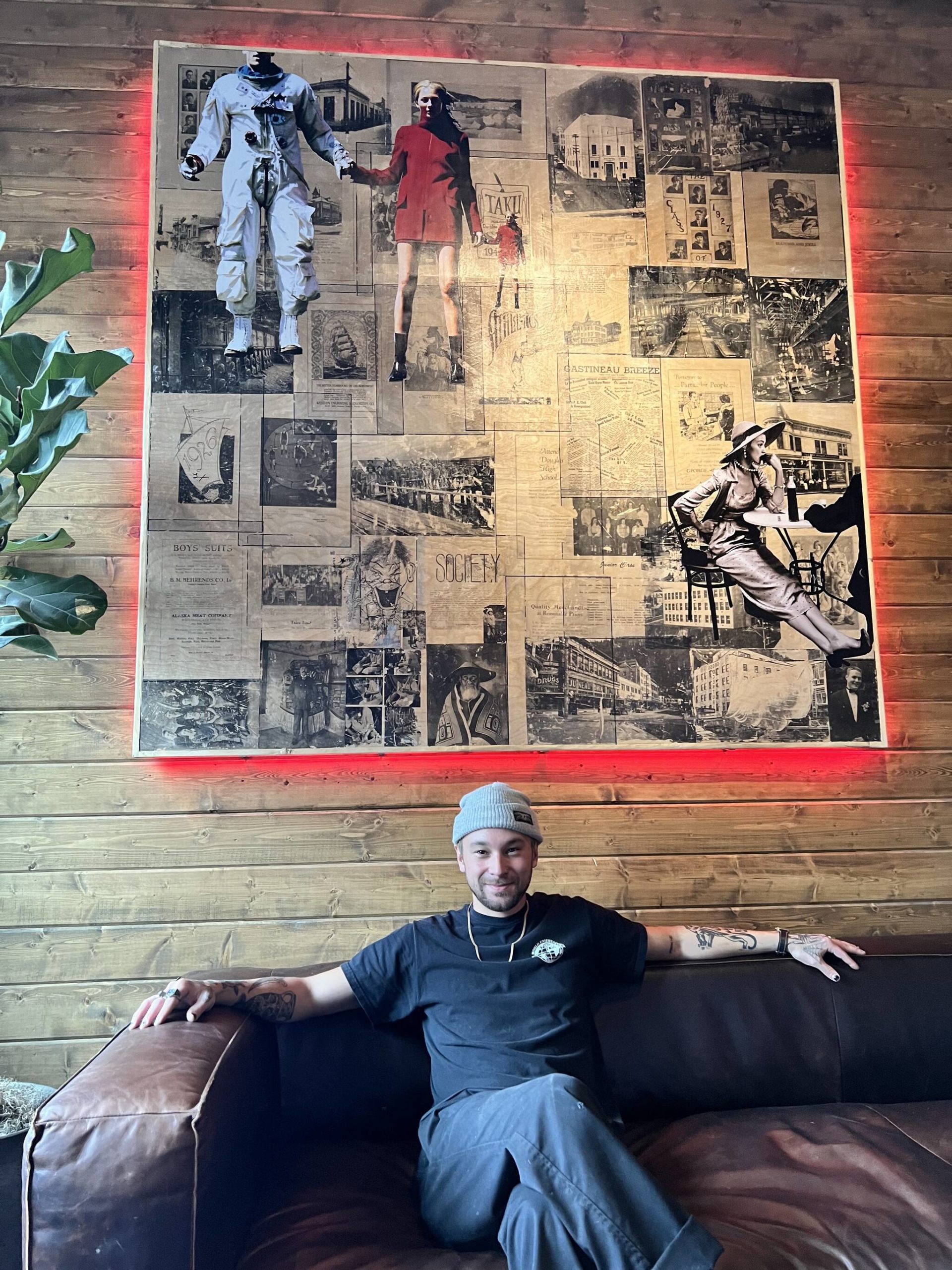 Alaska Native artist Logan Terry poses with his latest art installation currently hanging in the Bearcade above the Crystal Saloon. (Courtesy Photo / David Elrod)
