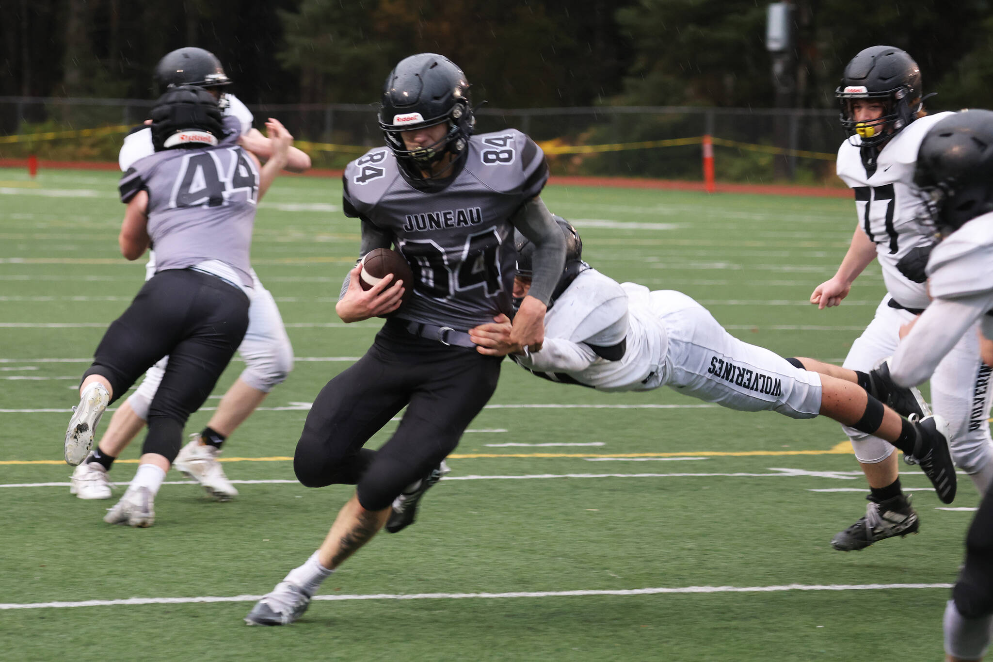 Thomas Baxter runs through an arm tackle on his way to the end zone in the fourth quarter of Saturday’s Huskies win.