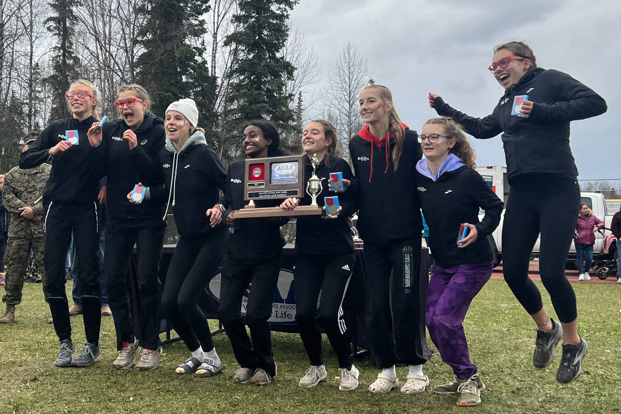 Juneau-Douglas High School: Yadaa.at Kalé’s varsity girls cross-country team attempts a jumping photo after winning the second place title at state meet over the weekend, hosted in Anchorage by Bartlett High School. (Courtesy / Christy Newell)