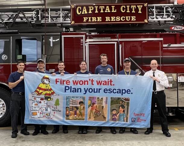 This photo shows ( from left to right) Capital City Fire/Rescue firefighters Bill McGoey, Karl Wuoti, Peter Flynn, Wendy Wallers, Captain Noah Jenkins, John Adams & Fire Marshal Dan Jager. (Courtesy Photo / Robin Lonas)