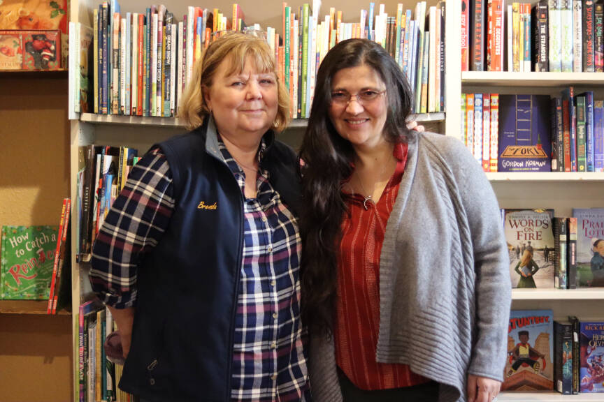 Brenda Weaver and Olga Lijó Seráns stand in Hearthside Books in downtown Juneau on Monday, Oct. 16, one day after Seráns took over as the official owner. Weaver, who had been the bookstore’s owner since 2014, said she looks forward to retirement and spending more time with friends and family. (Jonson Kuhn / Juneau Empire)