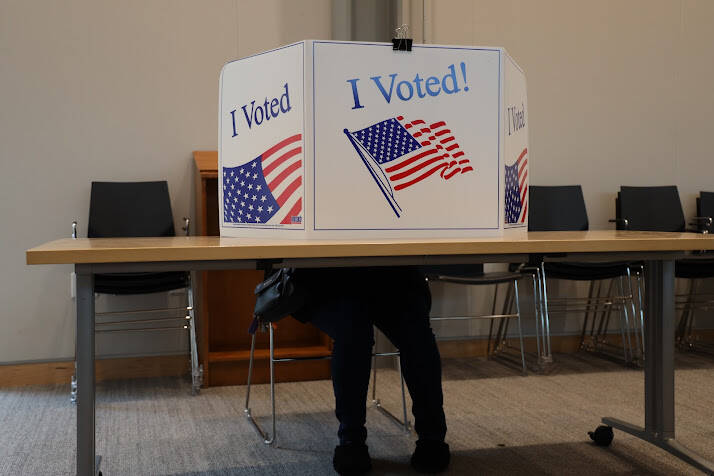 A voter sits behind a privacy screen while filling out a ballot during the City and Borough of Juneau 2022 municipal. The City and Borough of Juneau announced the final results of its 2022 local election showing a voter turnout just under 33% of all registered voters who participated in this year’s election.(Clarise Larson / Juneau Empire)