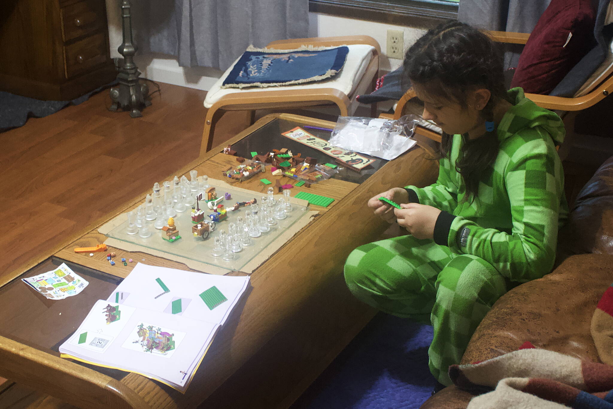 Mark Sabbatini / Juneau Empire 
Irynka Pomynalnyi, 10, plays with a chess set, Legos and other items in her family’s Mendenhall Valley home on Oct. 14, about three weeks after the family arrived in Juneau after fleeing the war in their homeland Ukraine.