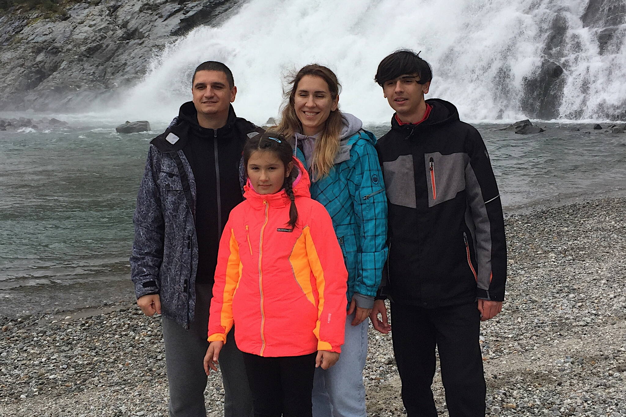 Andrii Pomynalnyi, left, his wife Olena, son Yehor and daughter Irynka visit Nugget Falls on Sept. 28, the same day the Ukrainian family arrived in Juneau after a journey that began Feb. 24 with Russian attacks near their home in Kyiv. The father said he is hoping the family can remain in Juneau for at least two years and possible beyond due to the destruction and future uncertainty in his homeland. (Courtesy of Kate Troll)