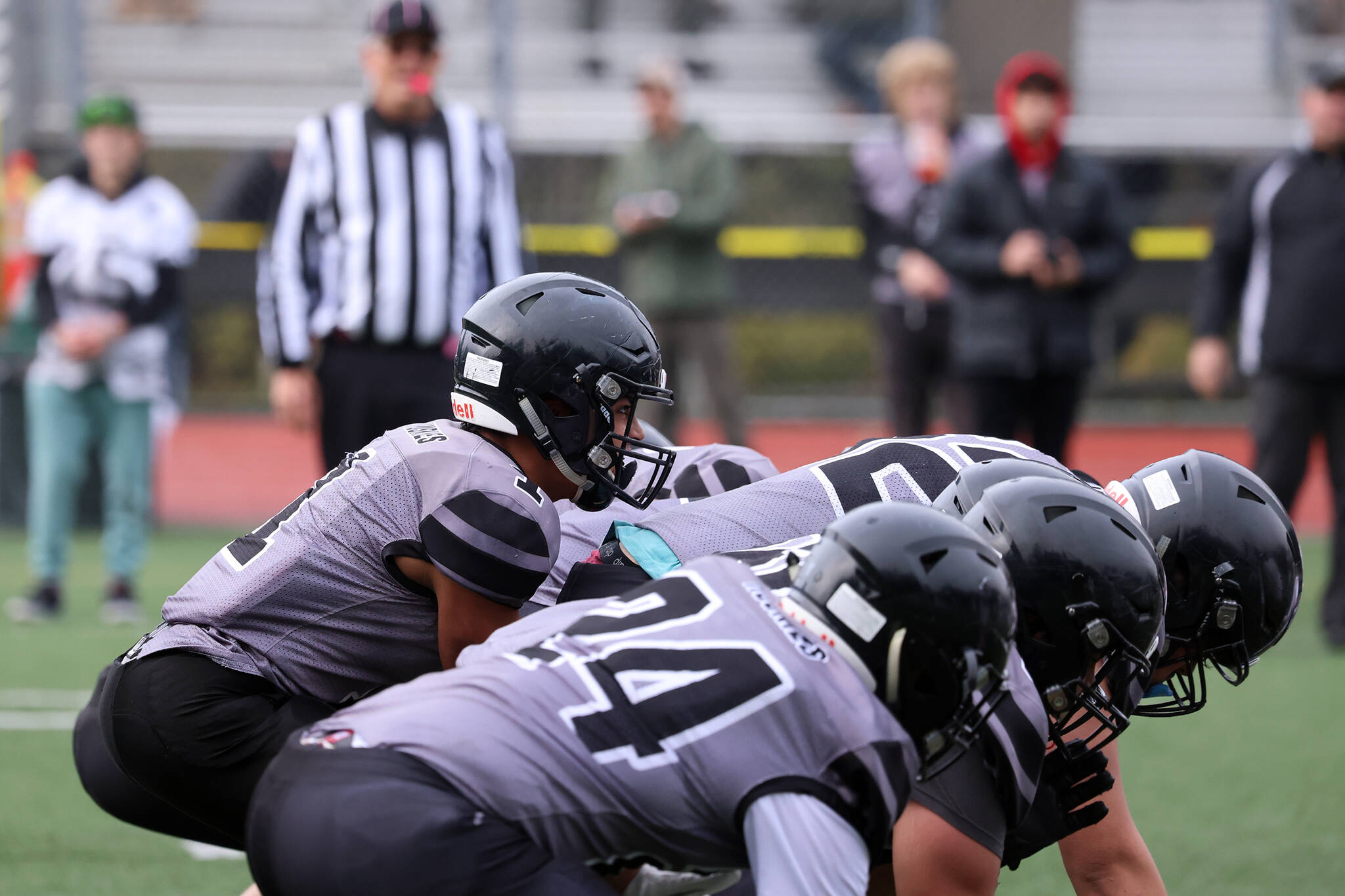 The Juneau Huskies offense prepares to kneel to end the half against the Bettye Davis East Anchorage High School Thunderbirds. Winning that game sent the unite Juneau high school football team to the