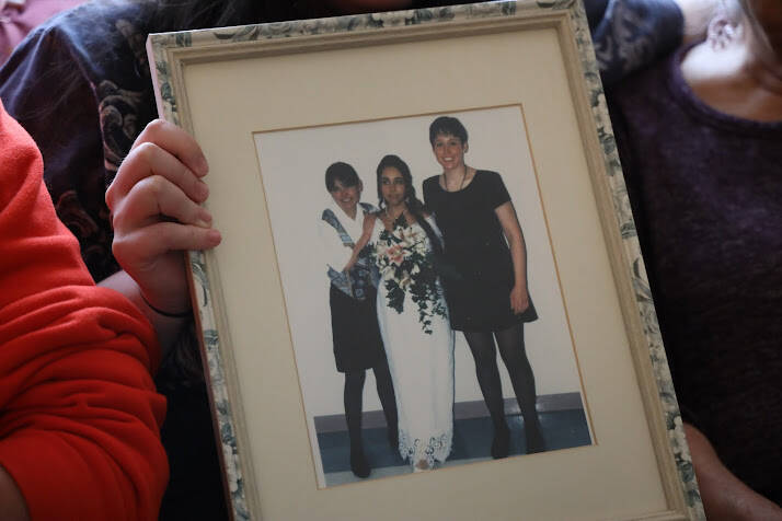 Harmony Wentz, Faith Rogers’ daughter, holds a framed picture showing a young Faith and her two sisters. According to Juneau Police Department spokesperson Lt. Krag Campbell, authorities are working to identify a suspect in Rogers’ death. (Clarise Larson/ Juneau Empire)