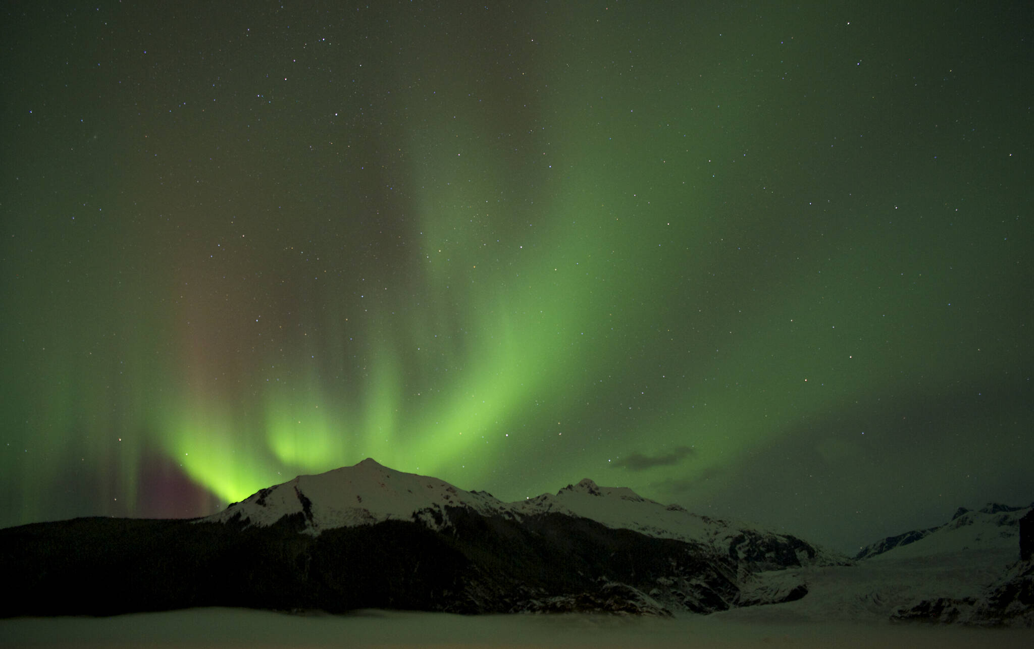 The Aurora Borealis glows over the Mendenhall Glacier in 2014. (Michael Penn / Juneau Empire File)