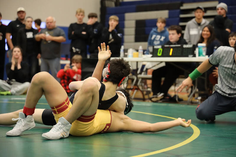 Thunder Mountain High School wrestler Brandon Day pins down his competition Saturday afternoon during the Brandon Pilot Invitational Wrestling Tournament at THMS. The Falcons had seven of its wrestlers make it into the finals and five took first in their weight divisions. (Clarise Larson / Juneau Empire)
