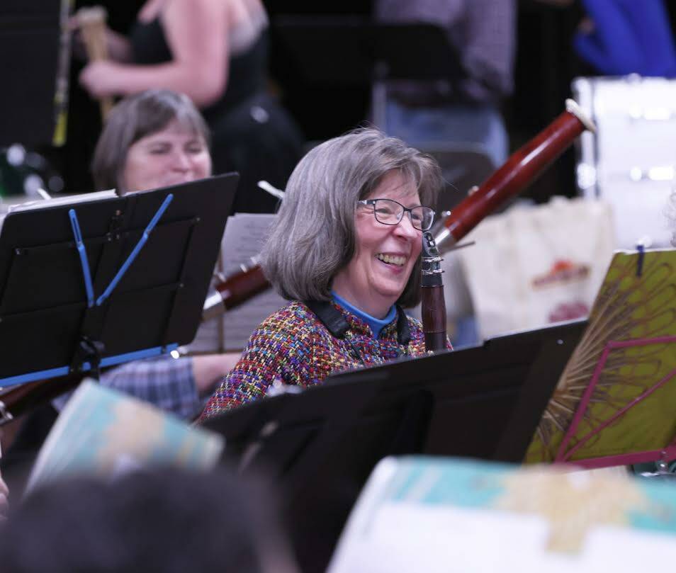 Sarah McNair-Grove laughs during a rehearsal for the upcoming Juneau Community Bands’ concert. The performance will include screening a short film depicting Godzilla destroying Las Vegas. (Ben Hohenstatt / Juneau Empire)