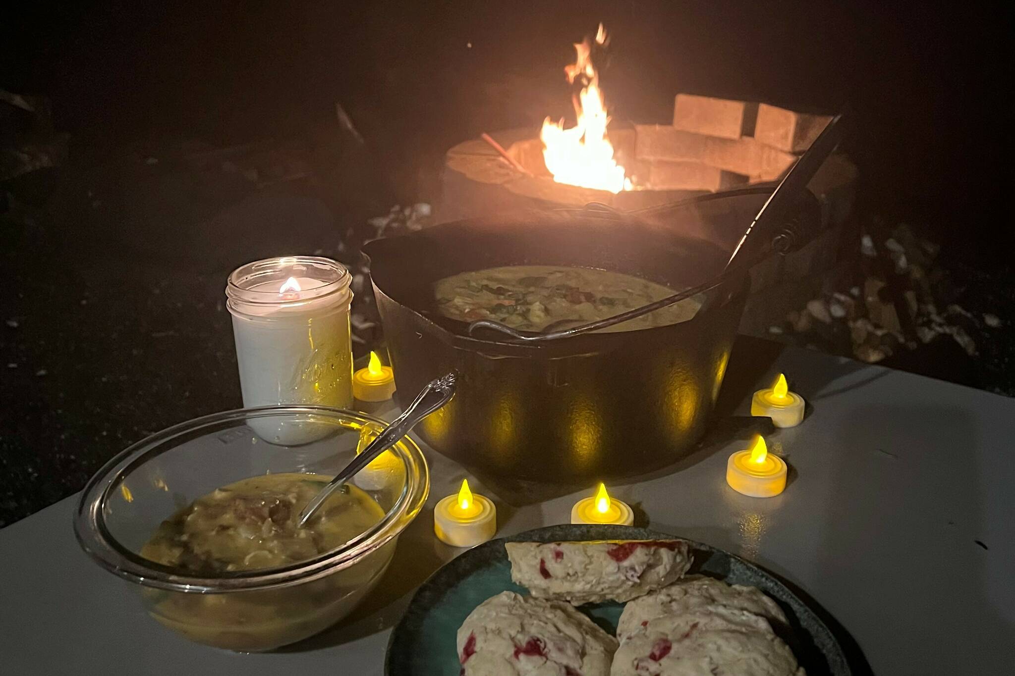 This photo shows a cauldron of halibut chowder around the firepit on a Fall evening. (Vivian Faith Prescott / For the Capital City Weekly)