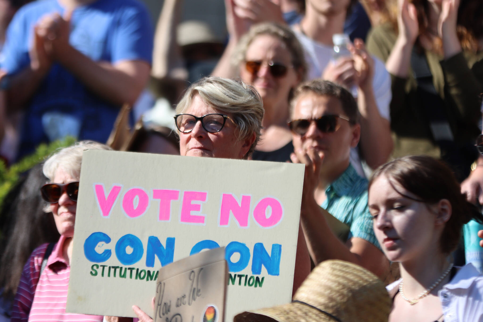 Former Democratic state Rep. Beth Kerttula holds up a sign reading “Vote No Con Con,” during a rally at the Dimond Courthouse Plaza in Juneau. (Ben Hohenstatt / Juneau Empire)