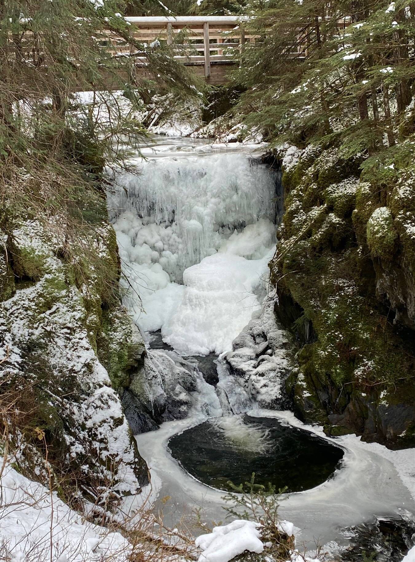 A bridge over an ice encrusted waterfall emptying into a glacial pool of water along Treadwell Ditch Trail on Nov. 9. (Courtesy Photo / Denise Carroll)