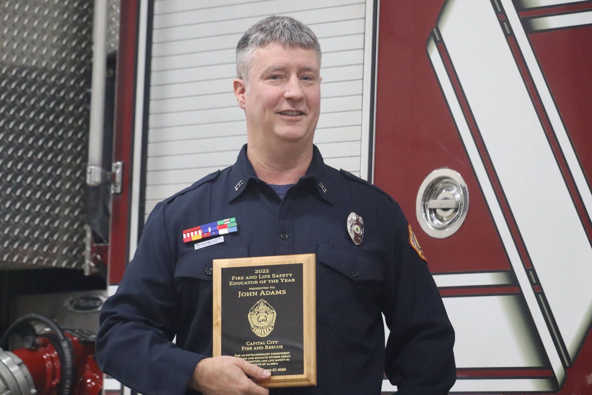 CCFR Acting Captain John Adams poses with plaque awarded at his presentation ceremony on Tuesday, Nov. 1. Adams was awarded the 2022 Fire Life Safety Educator of the Year for his dedication to educating Juneau youth and community of fire safety. (Jonson Kuhn / Juneau Empire)