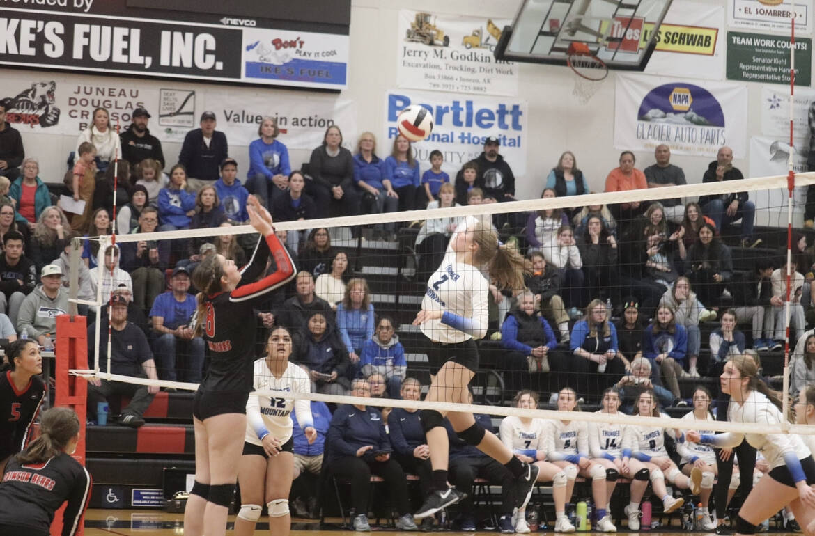 TMHS senior #2 Mallory Welling (2) prepares to spike the ball against JDHS juniors Mila Hargrave (8) and Kiah Yadao (5), with TMHS senior Moana Tuvaifale (12) stands nearby during the region V championship game on Saturday, Nov. 5. (Jonson Kuhn / Juneau Empire)