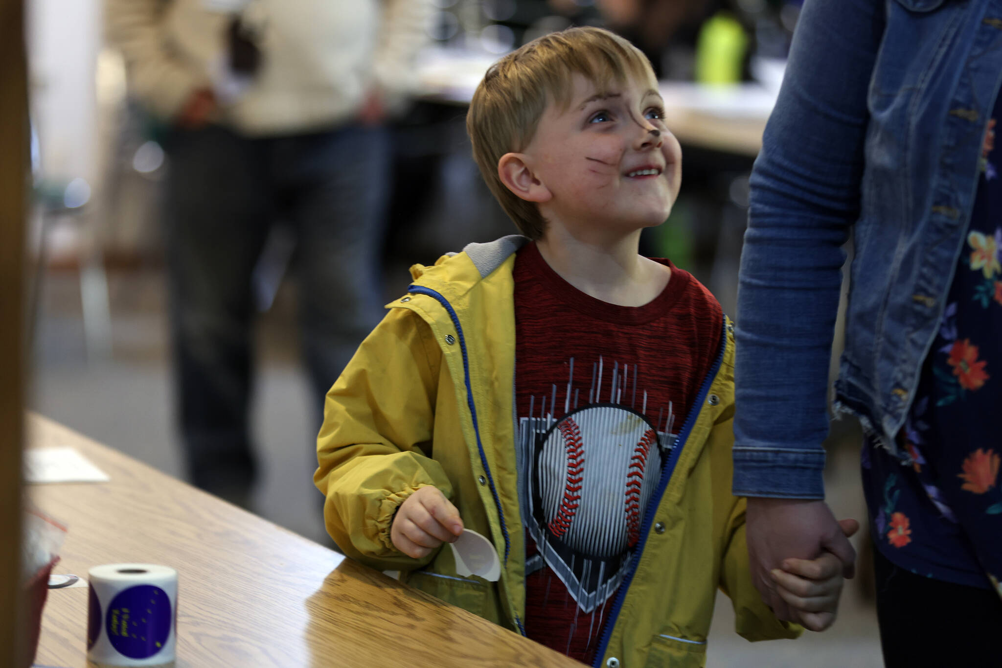 Rook Anderson, 5, beams after collecting an “I Voted” sticker at Shepherd of the Valley Lutheran Church on Tuesday evening. (Ben Hohenstatt / Juneau Empire)